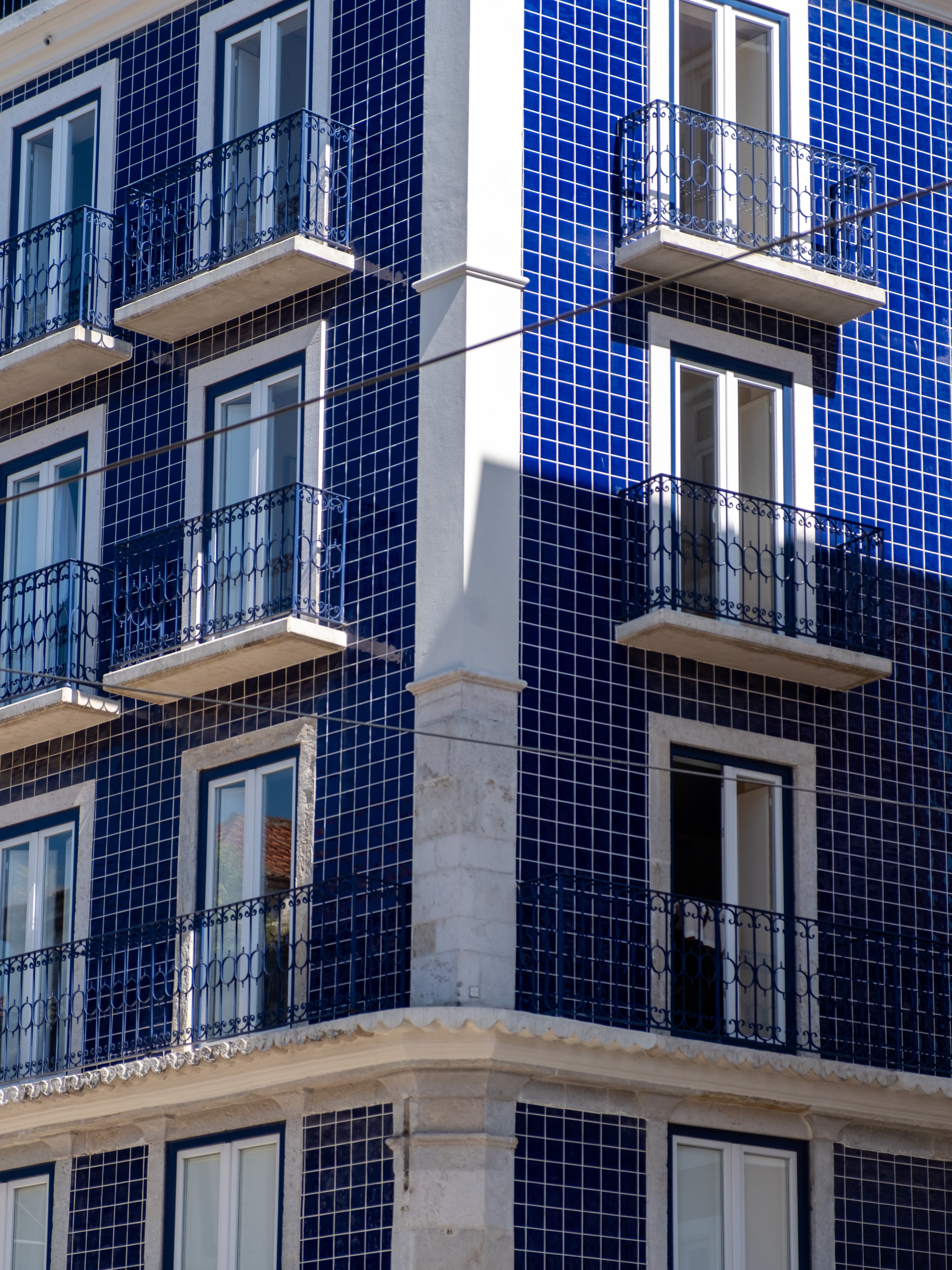 55mm · f/4 · 1/640s · ISO 200
FUJIFILM X-T5 · XF18-55mmF2.8-4 R LM OIS · May 10, 2024
Blue tiled building with white windows and balconies in Lisbon.
Lisbon, Portugal
© Brandon Cook