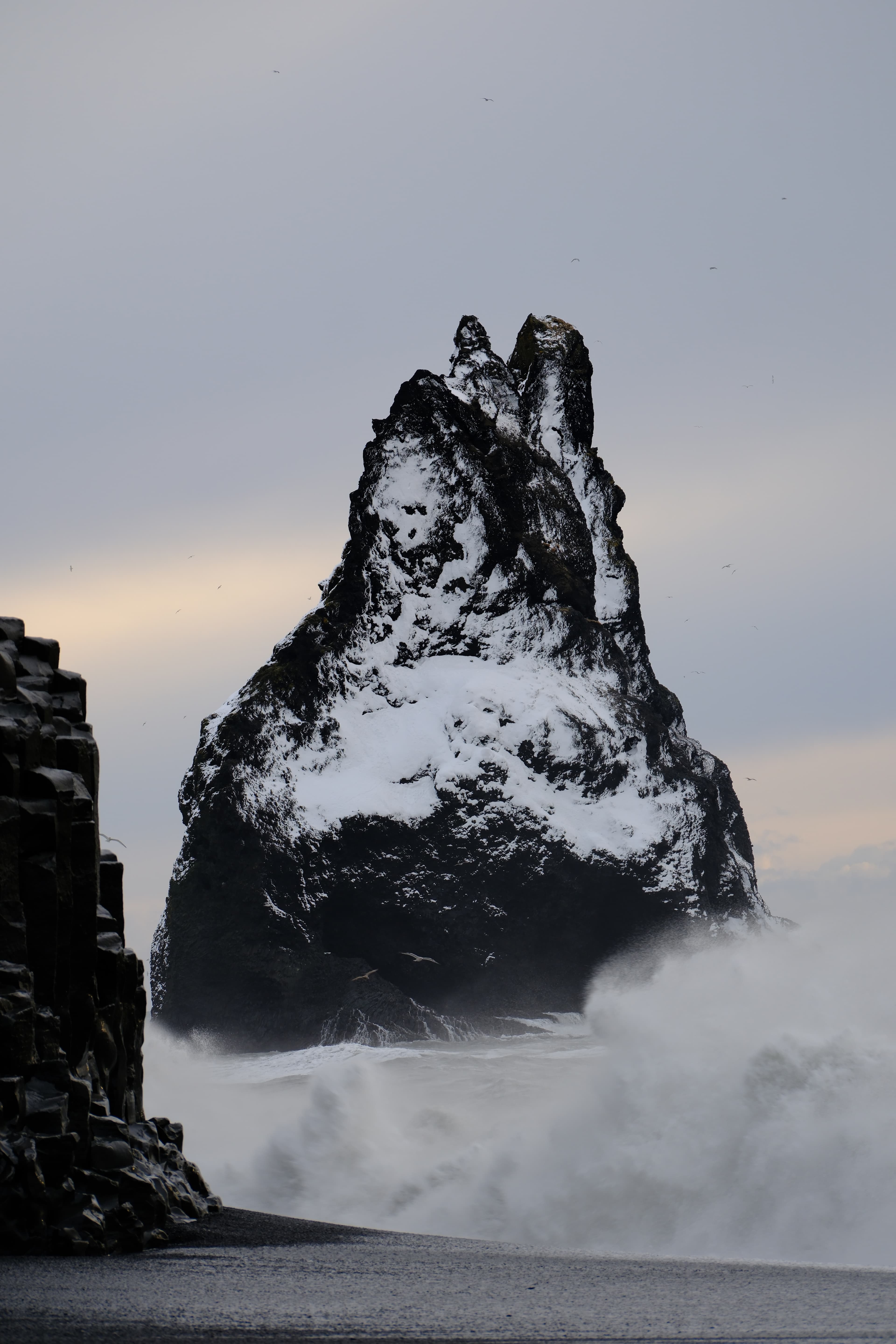 142mm · f/5 · 1/125s · ISO 160
FUJIFILM X-T5 · XF70-300mmF4-5.6 R LM OIS WR · Jan 25, 2025
Jagged snow-covered sea stack amidst crashing waves and mist.
Selfoss, Iceland
© Brandon Cook